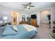 Tranquil main bedroom featuring plush carpeting, a ceiling fan, and an ensuite bathroom at 655 Conservation Blvd, Groveland, FL 34736