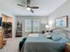 Serene main bedroom with a ceiling fan, soft lighting, and private ensuite bathroom access at 655 Conservation Blvd, Groveland, FL 34736