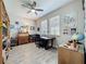 Bright home office with two windows, a ceiling fan, and a custom wood desk at 655 Conservation Blvd, Groveland, FL 34736