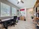 Well-lit home office with a large desk, custom shelving, and stylish decorations at 655 Conservation Blvd, Groveland, FL 34736