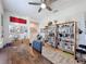 Inviting home office featuring custom bookshelves, a ceiling fan, and a large desk area at 655 Conservation Blvd, Groveland, FL 34736