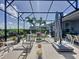 This screened-in patio offers ample seating, a dining area, and delightful views of the surrounding lush landscaping at 655 Conservation Blvd, Groveland, FL 34736