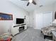 Comfortable sitting room with a ceiling fan, carpet flooring, and neutral colors at 655 Conservation Blvd, Groveland, FL 34736