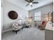 Cozy sitting room featuring neutral carpeting and two striped chairs at 655 Conservation Blvd, Groveland, FL 34736