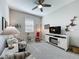 Bright sitting room with neutral carpeting, a ceiling fan, and comfortable seating at 655 Conservation Blvd, Groveland, FL 34736