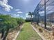 The backyard features a lovely screened-in patio, mature palms, and manicured landscaping, creating a tranquil retreat at 655 Conservation Blvd, Groveland, FL 34736