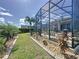 Beautiful backyard featuring a screened-in patio, lush landscaping, and well-maintained lawn for outdoor enjoyment at 655 Conservation Blvd, Groveland, FL 34736