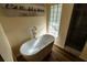 Soaking tub, glass block window, and tiled shower highlight this bathroom's spa-like retreat at 681 Greywood Dr, Altamonte Springs, FL 32701