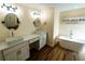 This stylish bathroom boasts double vanities, modern fixtures, and a luxurious soaking tub at 681 Greywood Dr, Altamonte Springs, FL 32701