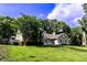 Lovely home with a well-manicured lawn and mature trees, providing shade and enhancing the property's beauty at 681 Greywood Dr, Altamonte Springs, FL 32701
