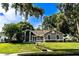 Charming one-story home with a manicured lawn and mature trees, creating a welcoming curb appeal at 681 Greywood Dr, Altamonte Springs, FL 32701