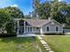 Beautifully landscaped front yard leading to a well-maintained home with a welcoming entrance and serene ambiance at 681 Greywood Dr, Altamonte Springs, FL 32701