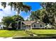 Charming single-Gathering home with a well-manicured lawn, complemented by mature trees and decorative landscaping at 681 Greywood Dr, Altamonte Springs, FL 32701