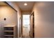 Hallway view towards an elegant bathroom with a freestanding tub and plenty of storage at 681 Greywood Dr, Altamonte Springs, FL 32701