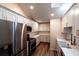 Updated kitchen with stainless steel appliances, white cabinets, and hard wood flooring at 681 Greywood Dr, Altamonte Springs, FL 32701