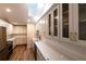 Kitchen boasts white cabinets, subway tile backsplash, quartz countertops, and stainless appliances at 681 Greywood Dr, Altamonte Springs, FL 32701