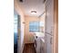 Laundry room featuring new washer/dryer, window, and cabinets with gold hardware at 681 Greywood Dr, Altamonte Springs, FL 32701