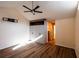 This airy main bedroom features wood floors, a ceiling fan, and built-in closet organizer at 681 Greywood Dr, Altamonte Springs, FL 32701