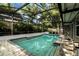 Inviting screened-in pool surrounded by lush landscaping and brick pavers, perfect for relaxation and outdoor entertainment at 681 Greywood Dr, Altamonte Springs, FL 32701