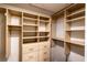 Walk-in closet featuring built in shelves, drawers, gold colored hardware and hanging racks at 681 Greywood Dr, Altamonte Springs, FL 32701