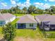 Home showcases a screened-in lanai and a fenced backyard with a lush, green lawn at 8128 Penrose Pl, Wildwood, FL 34785