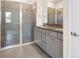 Modern bathroom featuring a large glass shower and granite countertops at 8128 Penrose Pl, Wildwood, FL 34785