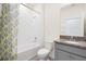 Bright bathroom with a tub-shower combo and a vanity with a granite countertop at 8128 Penrose Pl, Wildwood, FL 34785