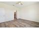 A cozy bedroom features hard wood floors and a ceiling fan at 8128 Penrose Pl, Wildwood, FL 34785