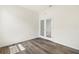 Bright bedroom featuring wood-look flooring and mirrored closet doors at 8128 Penrose Pl, Wildwood, FL 34785