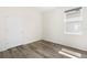 Bright bedroom featuring wood-look flooring and a window with natural light at 8128 Penrose Pl, Wildwood, FL 34785