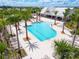 Community pool is surrounded by palm trees and features lounge chairs for relaxing at 8128 Penrose Pl, Wildwood, FL 34785