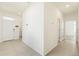 Open entryway with tile floors leading to multiple rooms, including a view of the laundry area at 8128 Penrose Pl, Wildwood, FL 34785