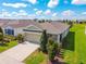 Charming single-story home boasts a well-manicured lawn and an attached two-car garage at 8128 Penrose Pl, Wildwood, FL 34785