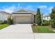 Charming single-Gathering home featuring a well-maintained lawn and a two-car garage at 8128 Penrose Pl, Wildwood, FL 34785