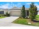 Welcoming home showcasing a manicured front yard and an attached two-car garage at 8128 Penrose Pl, Wildwood, FL 34785