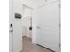 Hallway view with modern gray shelving leading to the laundry room at 8128 Penrose Pl, Wildwood, FL 34785