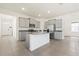 Bright kitchen features stainless steel appliances, gray cabinets, and a granite island at 8128 Penrose Pl, Wildwood, FL 34785