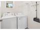 A laundry room with a washer, dryer, and overhead storage at 8128 Penrose Pl, Wildwood, FL 34785