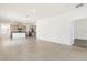 Open-concept living area with ceramic tile flooring and kitchen in the background at 8128 Penrose Pl, Wildwood, FL 34785