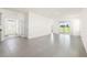 Open-concept living room with ceramic tile flooring and sliding glass doors to the backyard at 8128 Penrose Pl, Wildwood, FL 34785