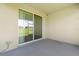 An open patio with a sliding glass door accessing the backyard at 8128 Penrose Pl, Wildwood, FL 34785