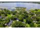 Beautiful lake view with homes nestled in lush greenery, private dock, and tranquil scenery at 9223 Silver Lake Dr, Leesburg, FL 34788