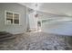 Exterior patio with high ceilings, brick flooring, and access to the home and yard at 9223 Silver Lake Dr, Leesburg, FL 34788