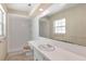 Clean bathroom with white tile, a large mirror, and a window for natural light at 9223 Silver Lake Dr, Leesburg, FL 34788