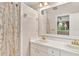 Bathroom featuring a shower/tub combo, double sinks, large mirror, and modern lighting at 9223 Silver Lake Dr, Leesburg, FL 34788