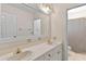 Dual sink bathroom features ample counter space, large mirror, and convenient access to a shower at 9223 Silver Lake Dr, Leesburg, FL 34788