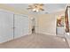 Spacious bedroom boasts a large closet, carpet, ceiling fan, and access to a bathroom and other rooms at 9223 Silver Lake Dr, Leesburg, FL 34788