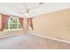 Spacious bedroom with carpet, ceiling fan, and large windows with nice views at 9223 Silver Lake Dr, Leesburg, FL 34788