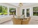 Bright breakfast nook featuring wicker chairs, a glass table, and scenic views at 9223 Silver Lake Dr, Leesburg, FL 34788