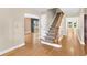 Open entryway features hardwood floors, staircase and natural light coming through large windows at 9223 Silver Lake Dr, Leesburg, FL 34788